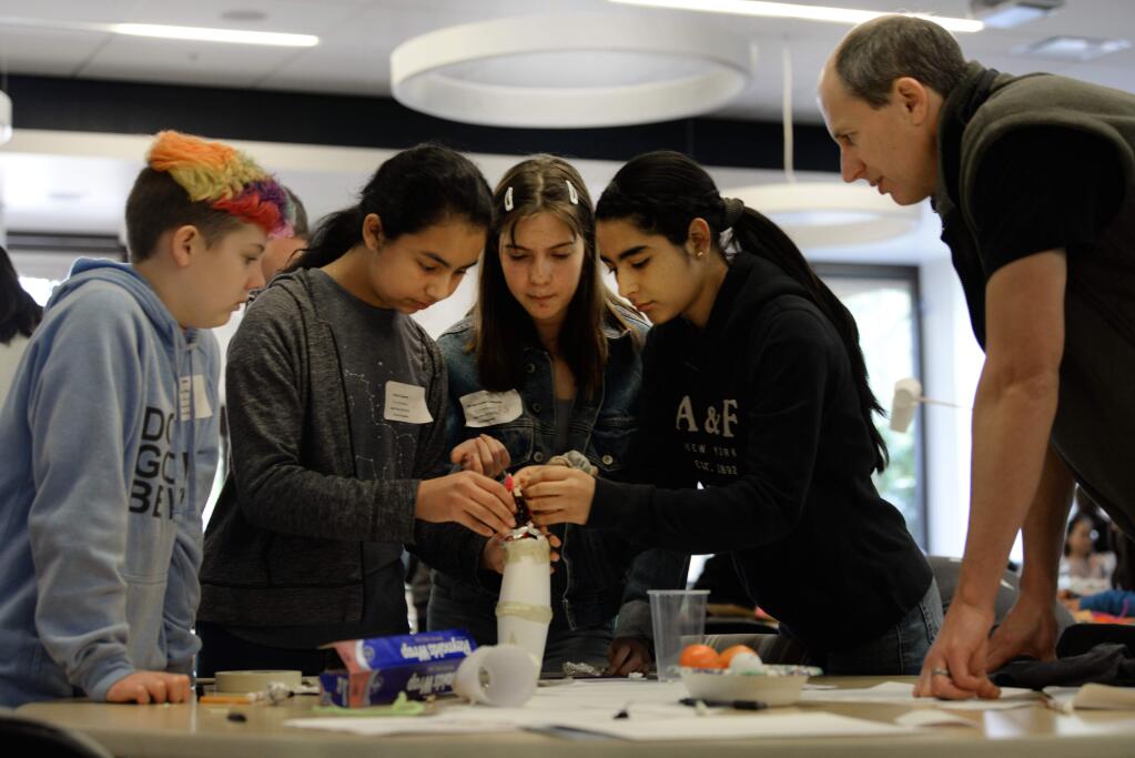 From left, Olivia Lillig, 13, Jenna Cisneros, 11, Mirium Landau-Camarillo, 13, and Karol Real Vega, 15 collaborating on their landing device design with R&D Engineer Cameron Blatter, far right, during Introduce a Girl to Engineering Day held Saturday at Keysight Technologies in Santa Rosa, California. The hands-on event for female students in grades 6-12 offered a day of learning engineering, mathematics and science skills in an effort to inspire participants to enter the STEM field. February 23, 2019.(Photo: Erik Castro/for The Press Democrat)