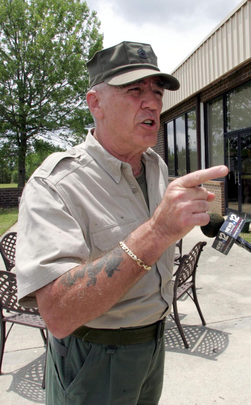 FILE - In this May 15, 2006, file photo, retired Marine Gunnery Sgt. R. Lee Ermey gives a few Marines a show outside New River Air Station's Staff NCO club in Jacksonville, N.C. Ermey, a former marine who made a career in Hollywood playing hard-nosed military men like Gunnery Sgt. Hartman in Stanley Kubrick's 'Full Metal Jacket,' has died. His longtime manager Bill Rogin says he died Sunday morning, April 15, 2018, from pneumonia-related complications. He was 74. (Randy Davey/The Jacksonville Daily News via AP, File)