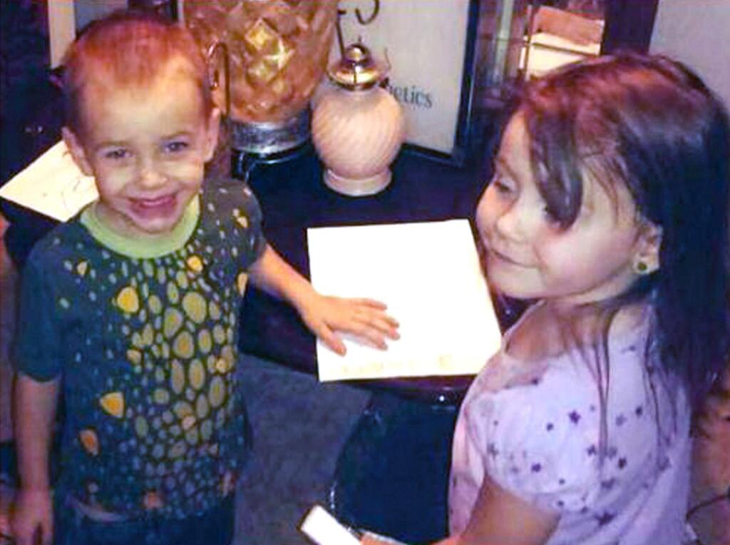 This undated photo provided by the Los Angeles County Sheriff's Department shows Brayden Watkins, 3, left, and Rylee Watkins, 5, who have gone missing along with their 2-year-old sister Joslynn Watkins. Authorities are seeking Joshua Robertson, 27, and Brittany Humphrey, 22, who they believe were involved in the killing of children's mother, Kimberly Harvill, and may have fled California with the children. (Los Angeles County Sheriff's Department via AP)