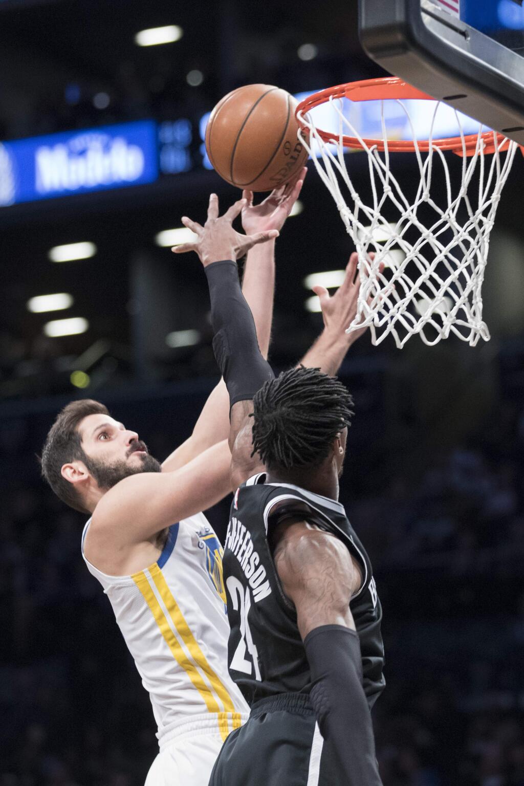 The Golden State Warriors forward Omri Casspi, left, goes to the basket against Brooklyn Nets forward Rondae Hollis-Jefferson during the first half Sunday, Nov. 19, 2017, in New York. (AP Photo/Mary Altaffer)
