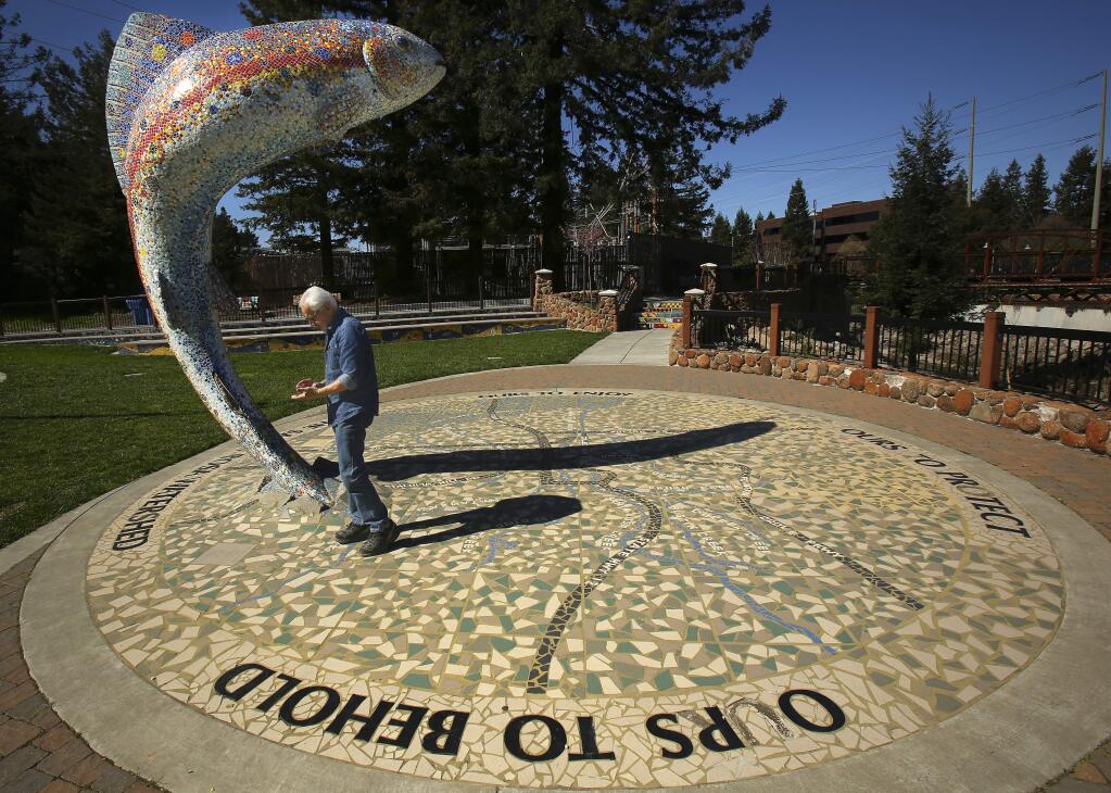 Artist Mario Uribe with his mosaic fish statue at the Prince Memorial Greenway entrance in Santa Rosa. (Conner Jay/PD FILE)