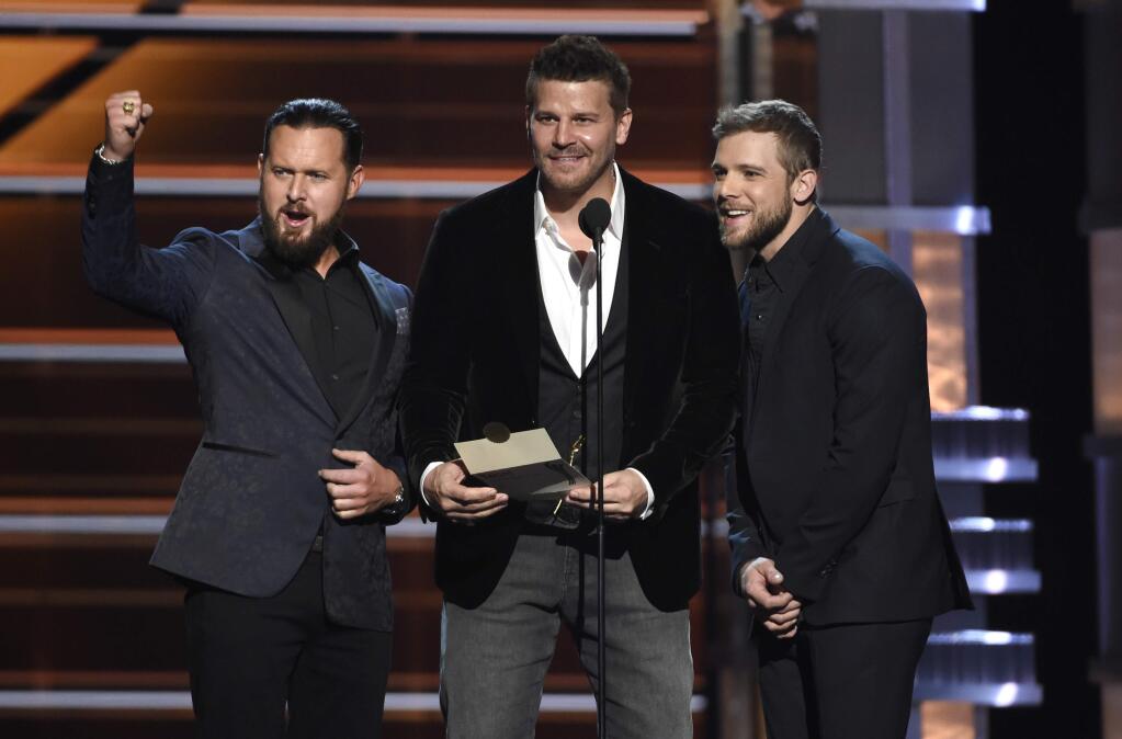 A.J. Buckley, from left, David Boreanaz, and Max Thieriot present the award for vocal group of the year at the 53rd annual Academy of Country Music Awards at the MGM Grand Garden Arena on Sunday, April 15, 2018, in Las Vegas. (Photo by Chris Pizzello/Invision/AP)