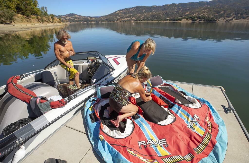 From left, Jimmie McManus, Bobbie Goodyear and Cynthia Clark of Cloverdale prepare for an afternoon boating at Lake Mendocino on Monday. They say this is the most water they've seen in the lake in early fall since they starting camping there 15 years ago. (photo by John Burgess/The Press Democrat)