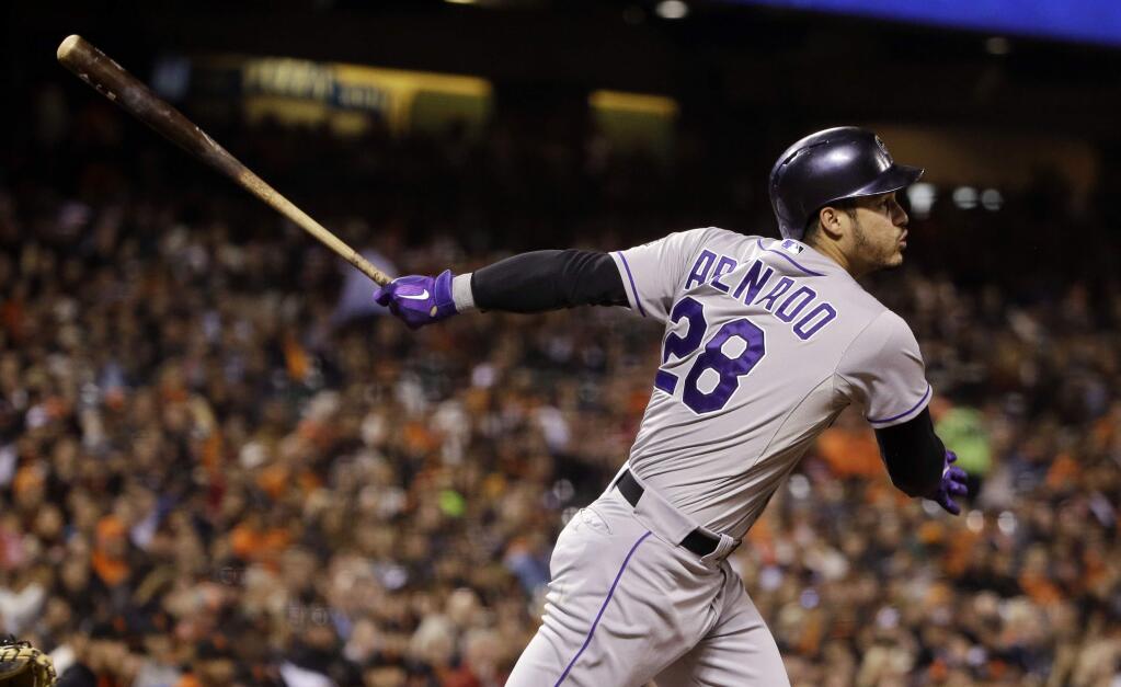 Colorado Rockies' Nolan Arenado drives in two runs with a double against the San Francisco Giants during the third inning of a baseball game Friday, Oct. 2, 2015, in San Francisco. (AP Photo/Marcio Jose Sanchez)