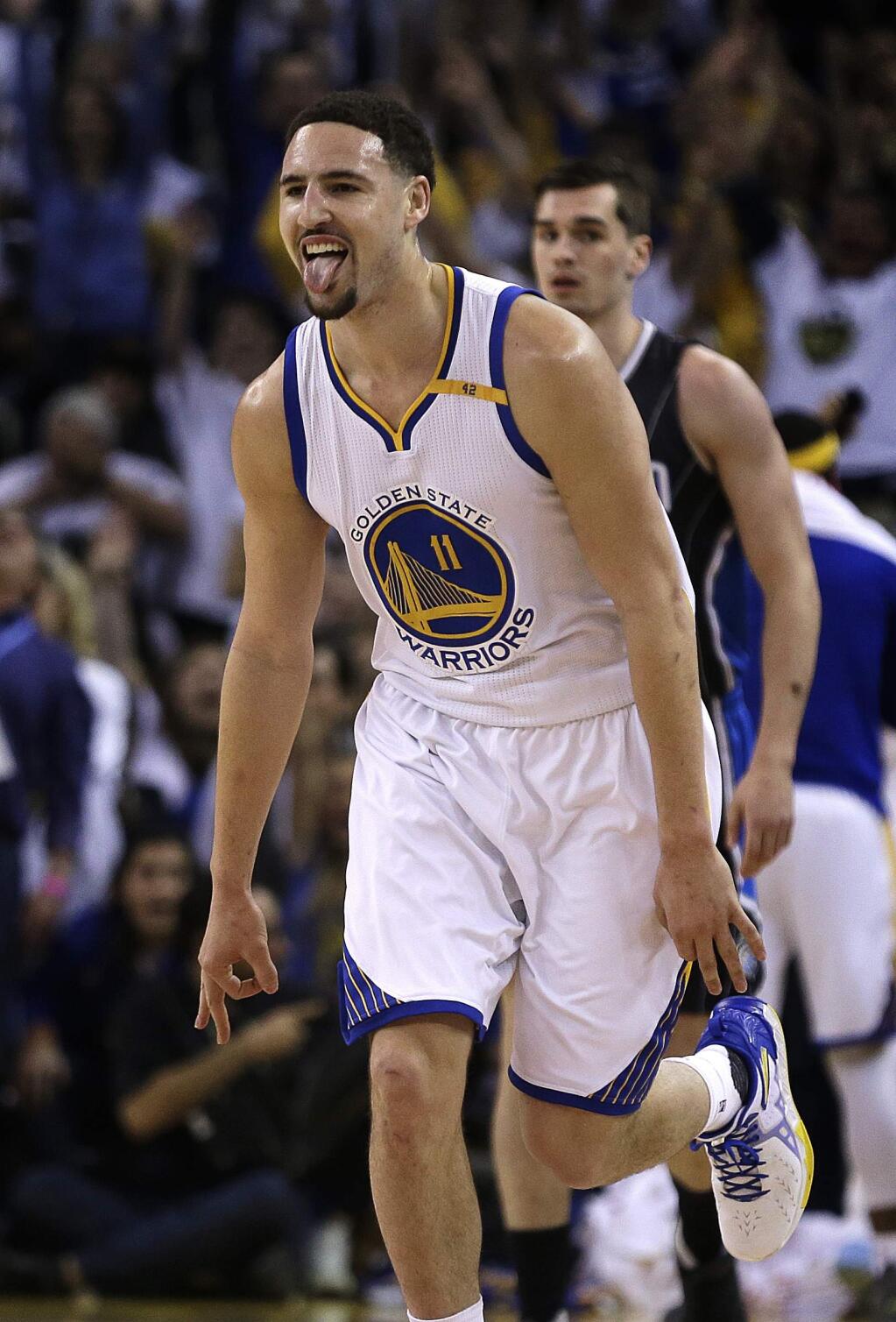 Golden State Warriors' Klay Thompson celebrates a score against the Orlando Magic during the first half of an NBA basketball game Thursday, March 16, 2017, in Oakland, Calif. (AP Photo/Ben Margot)