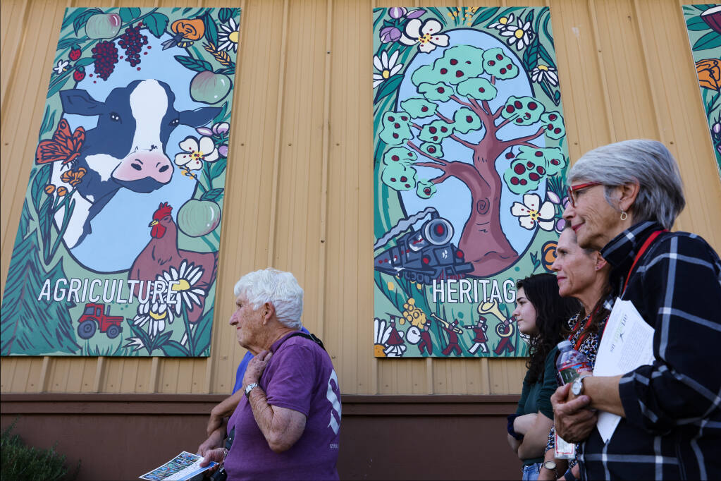 People attend the dedication of the new World of Good mural by Artstart, in collaboration with Analy High School art students, at the Goodwill building in Sebastopol on Tuesday, Oct. 18, 2022. (Christopher Chung/The Press Democrat)