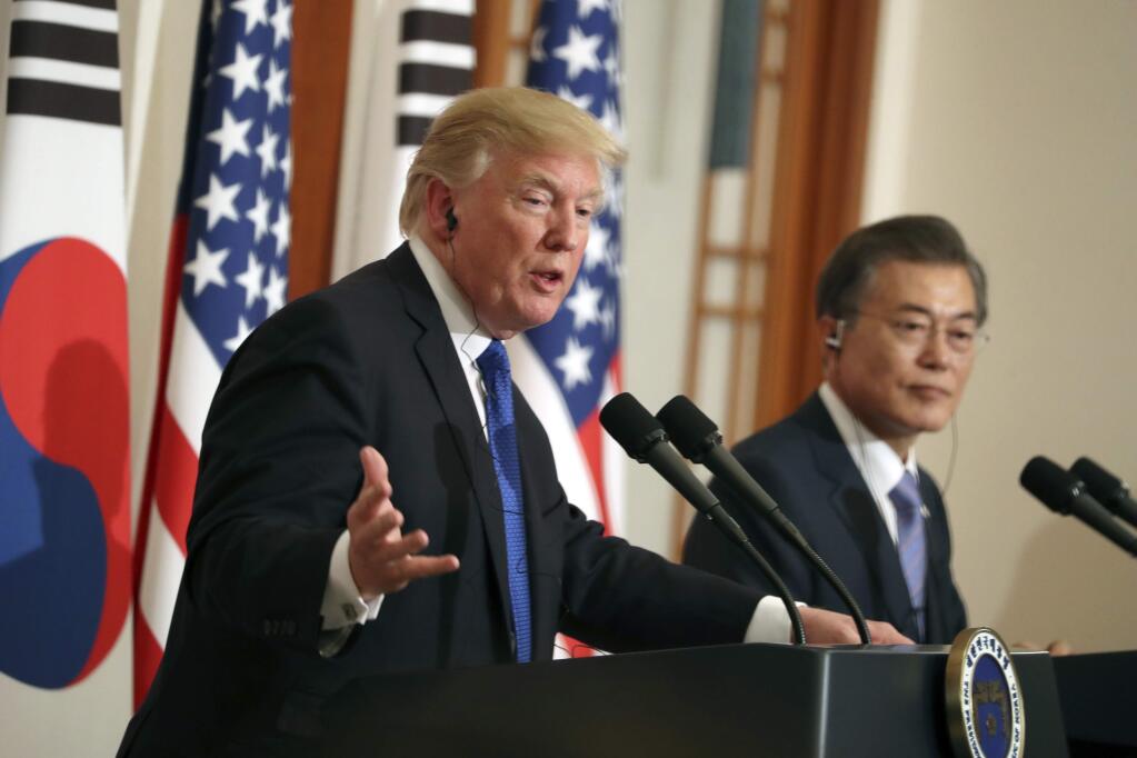 President Donald Trump, left, speaks as South Korean President Moon Jae-in looks on in a joint news conference at the Blue House in Seoul, South Korea, Tuesday, Nov. 7, 2017. President Trump began his two-day Korean peninsula visit Tuesday walking amid weapons of war but voicing optimism for peace. Trump is on a five country trip through Asia traveling to Japan, South Korea, China, Vietnam and the Philippines. (AP Photo/Andrew Harnik)