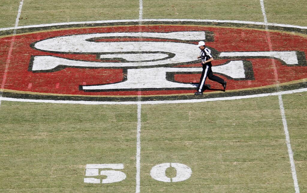Referee Tony Corrente runs toward the 50-yard line of Levi's Stadium field during the third quarter of an NFL preseason football game between the San Francisco 49ers and the San Diego Chargers in Santa Clara, Calif., Sunday, Aug. 24, 2014. (AP Photo/Mathew Sumner)
