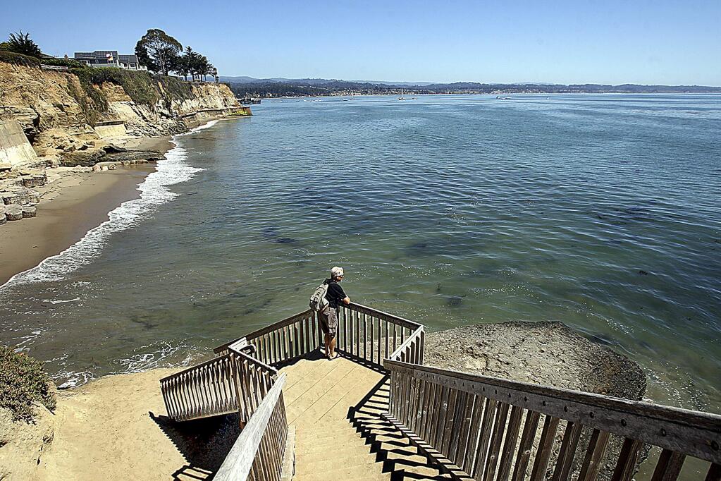This Aug. 31, 2016, photo shows a staircase from Opal Cliffs Park that leads to Opal Cliffs Neighborhood Beach, more commonly known as Privates, in the Live Oak neighborhood of an unincorporated part of Santa Cruz County, Calif. The California Coastal Commission will decide whether access to a secluded beach can be restricted by a 9-foot iron fence, locking gate with a $100 annual key fee and a gate attendant. The commission on Thursday, July 12, 2018 will vote on whether the resident-run program that has regulated access to Santa Cruz County's Privates Beach for more than 50 years is allowed to continue. (Dan Coyro/Santa Cruz Sentinel via AP)