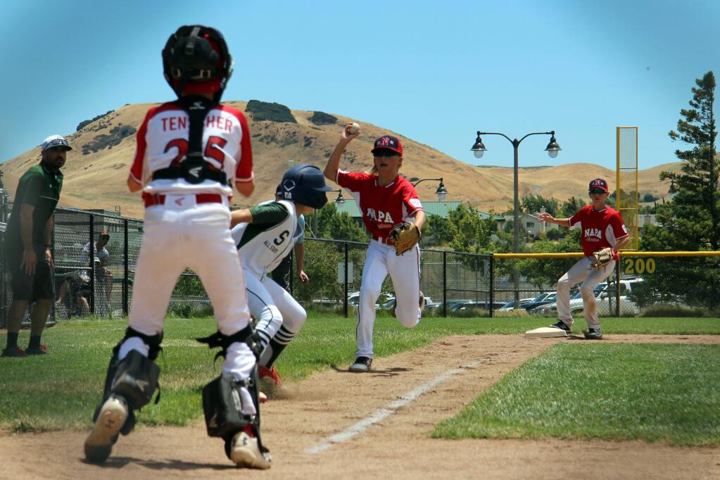 Caught in a pickle between third and home, Ben Sebastiani (#26) eventually scores against Napa American on July 7 on a throwing error. (August Sebastiani)