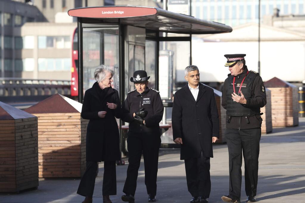 Mayor of London, Sadiq Khan, centre right, Metropolitan Police Commissioner, Cressida Dick, center left, and Commissioner of the City of London Police, Ian Dyson, right, walk across London Bridge in central London, Saturday, Nov. 30, 2019, after an attack on Friday. UK counterterrorism police on Saturday searched for clues into how a man imprisoned for terrorism offenses before his release last year managed to stab several people before being tackled by bystanders and shot dead by officers on London Bridge. Two people were killed and three wounded. (Steve Parsons/PA via AP)