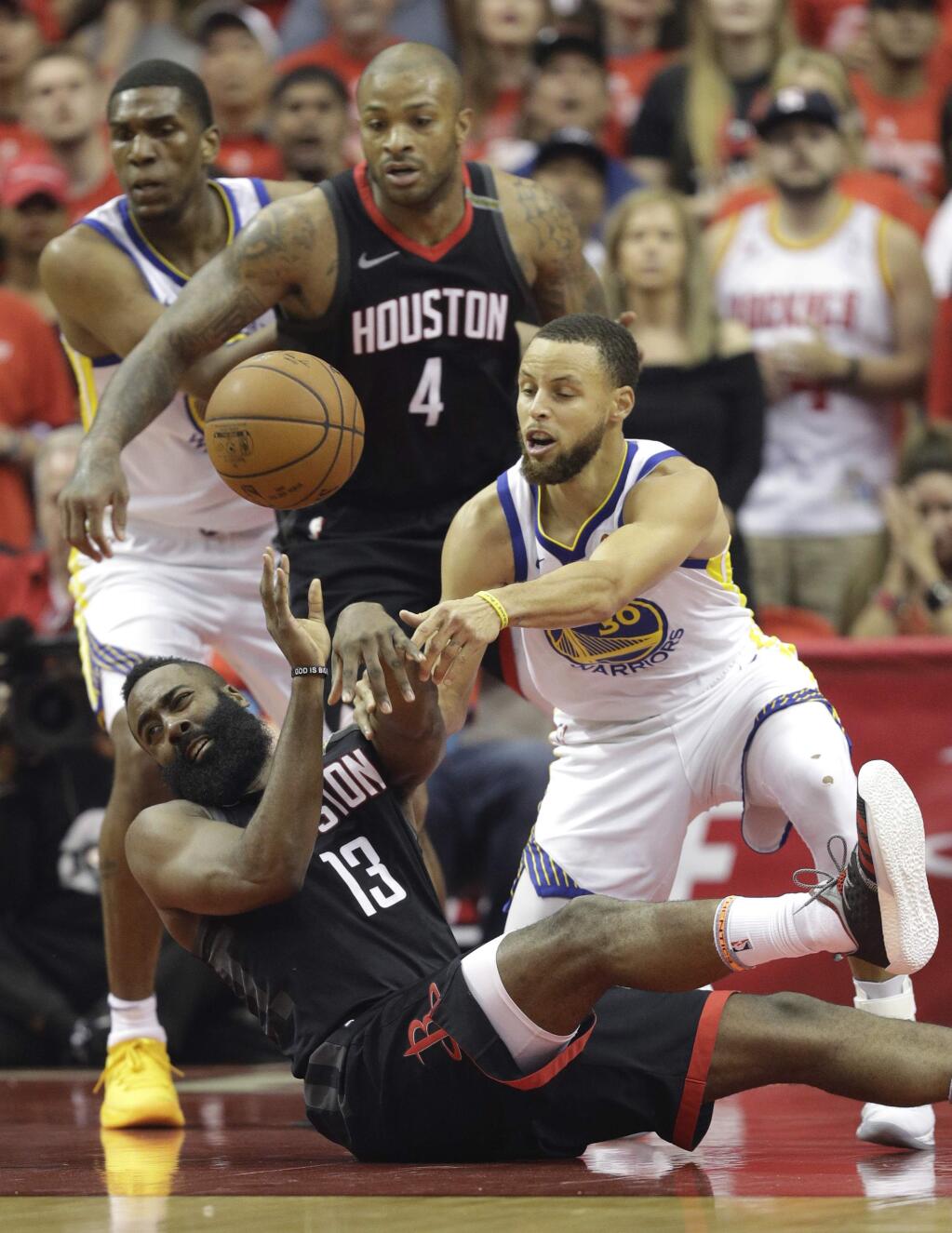 Houston Rockets guard James Harden (13) and Golden State Warriors guard Stephen Curry (30) scramble for a loose ball during the first half in Game 7 of the NBA basketball Western Conference finals, Monday, May 28, 2018, in Houston. (AP Photo/David Phillip)