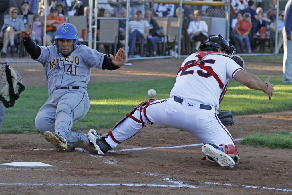 Bill Hoban/Index-TribuneSonoma Stomper catcher Issac Wenrichtries to grab for the ball as Vallejo runner Deybi Garcia scored during Tuesday night's game. Vallejo took an early lead, but the Stompers roared back and bludgeoned the Admirals 17-6. Sonoma also won Wednesday, 4-2.