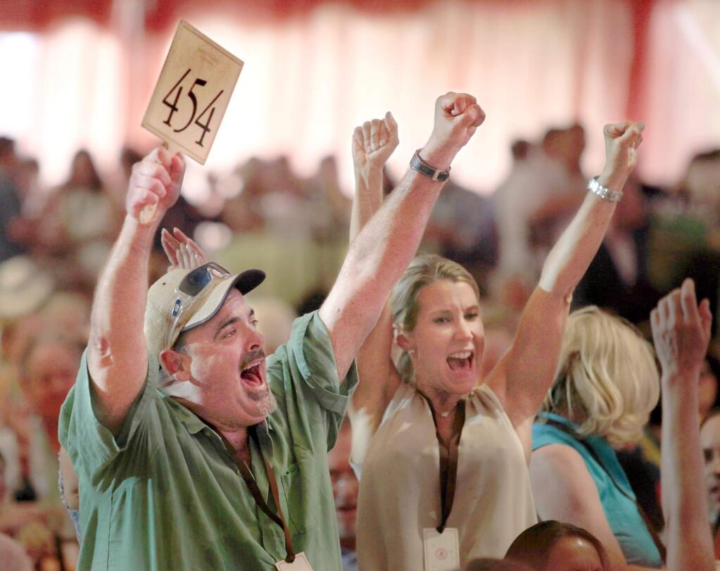 Jeffrey Miller of Miami celebrates a winning bid at Auction Napa Valley at Meadowood Resort in St. Helena. (Kent Porter / PD FILE 2013)