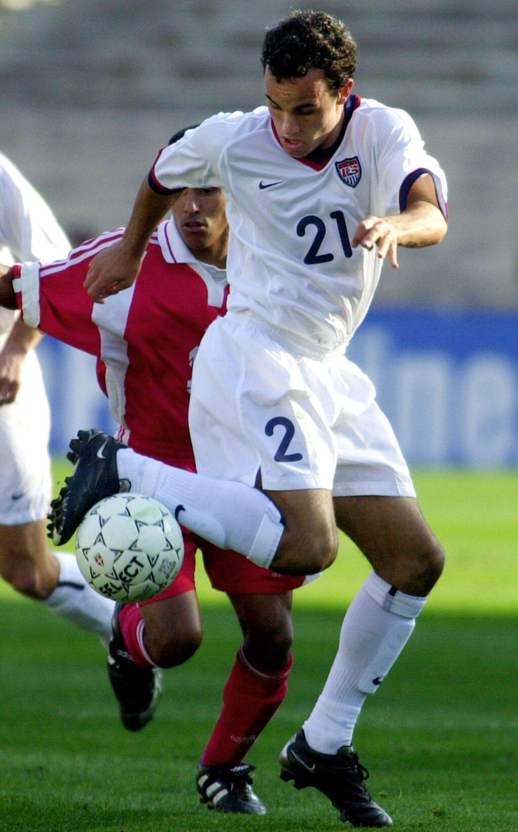United States' Landon Donovan (21) stop the ball with his foot against Cuba's Chris Armas during the first half of Gold Cup soccer tournament at the Rose Bowl in Pasadena, Calif., Monday, Jan. 21, 2002. (AP Photo/Nick Ut)