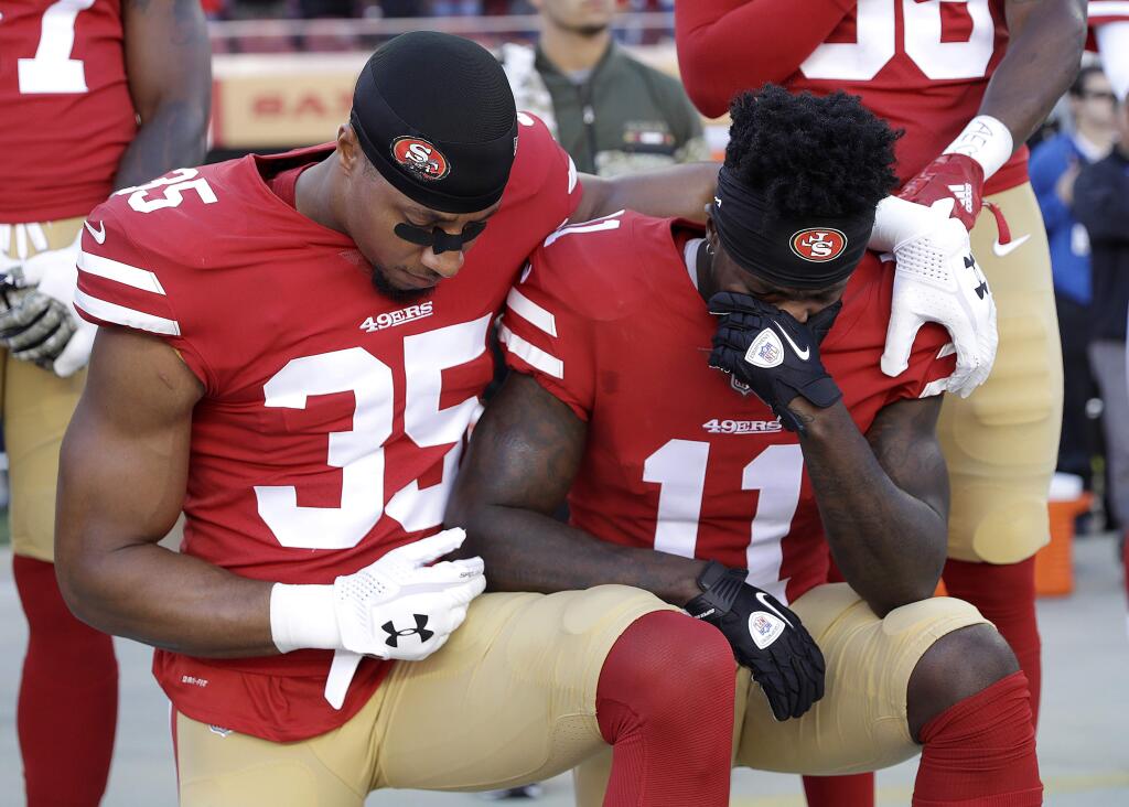 San Francisco 49ers safety Eric Reid (35) and wide receiver Marquise Goodwin (11) kneel during the performance of the national anthem before an NFL football game against the New York Giants in Santa Clara, Calif., Sunday, Nov. 12, 2017. (AP Photo/Marcio Jose Sanchez)