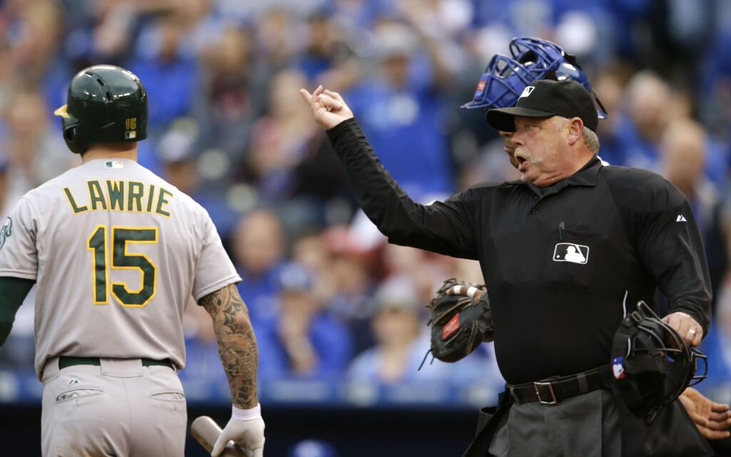 Umpire Jim Joyce, right, ejects Kansas City Royals starting pitcher Yordano Ventura during the fourth inning after hitting Oakland Athletics' Brett Lawrie (15) with a pitch at Kauffman Stadium in Kansas City, Mo., Saturday, April 18, 2015. (AP Photo/Orlin Wagner)