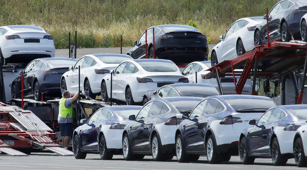 Tesla cars are loaded onto carriers at the Tesla electric car plant in Fremont on May 13. California Gov. Gavin Newsom said Sept. 23 that the state will halt sales of new gasoline-powered passenger cars and trucks by 2035. He ordered state regulators to come up with requirements to meet that goal. California would be the first state with such a rule, though Germany and France are among 15 other countries that have a similar requirement. (AP Photo/Ben Margot)