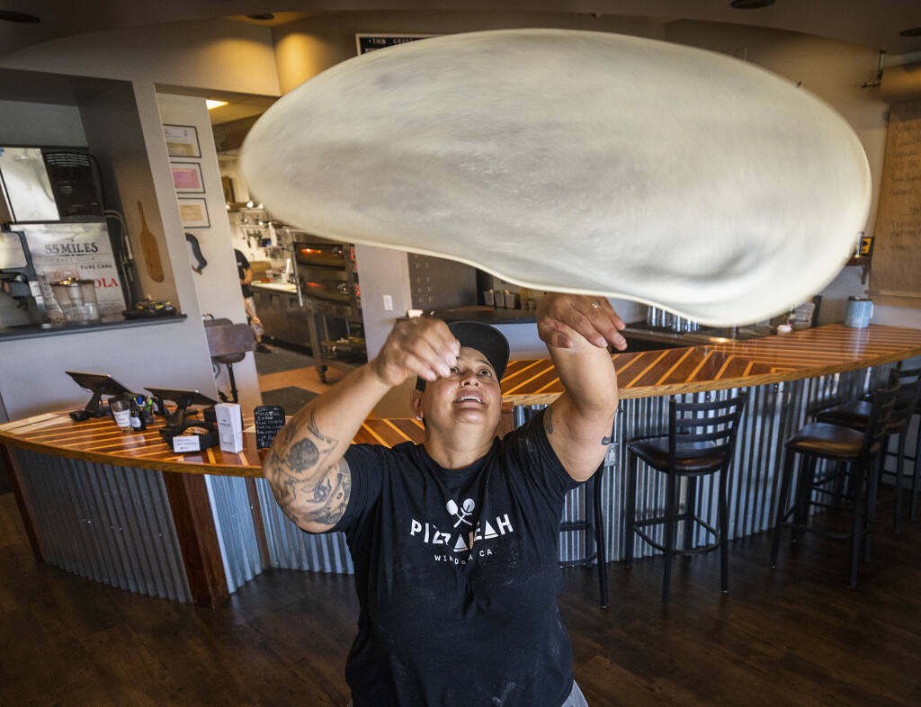 Leah Scurto, owner of PizzaLeah tosses pizza dough in her Windsor restaurant, Wednesday, Sept. 27, 2022. Scuto competed for best pizza maker on Hulu’s “Best in Dough,” streaming now. (John Burgess/The Press Democrat)