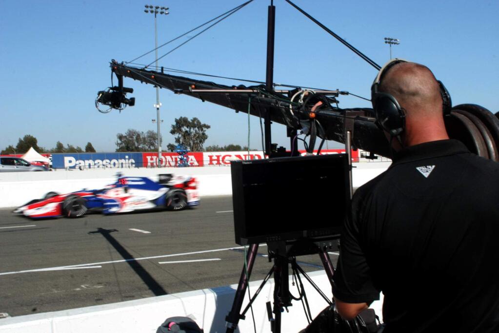 A track-side cameraman catches the action at Sonoma Raceway as the track prepares for the season finale of the Verizon IndyCar series, Sept. 16-18. (Christian Kallen/Index-Tribune)
