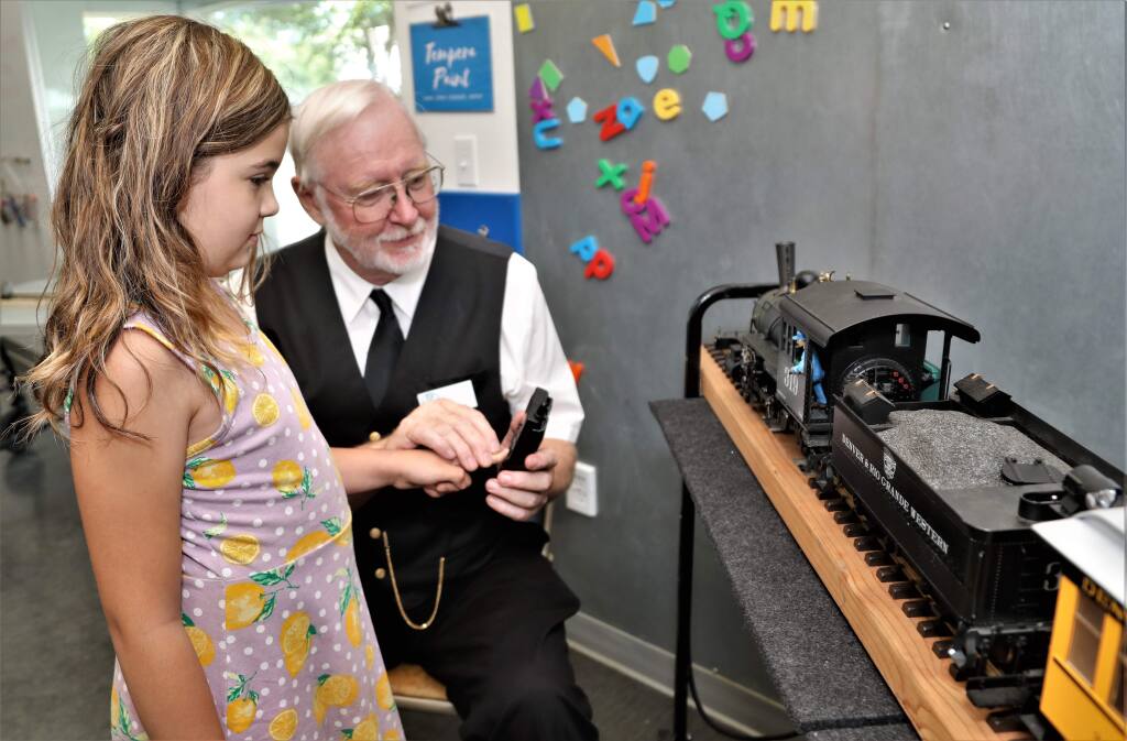 Adalia Petersen, 9, learns how to operate the train with Jim Cunningham at the Great Train Days Celebration put on by the Redwood Empire Garden Railway Society at the Children's Museum of Sonoma County in Santa Rosa on Saturday, July 27, 2019. (WILL BUCQUOY/ FOR THE PD)