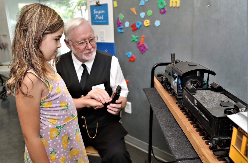 Adalia Petersen, 9, learns how to operate the train with Jim Cunningham at the Great Train Days Celebration put on by the Redwood Empire Garden Railway Society at the Children's Museum of Sonoma County in Santa Rosa on Saturday, July 27, 2019. (WILL BUCQUOY/ FOR THE PD)