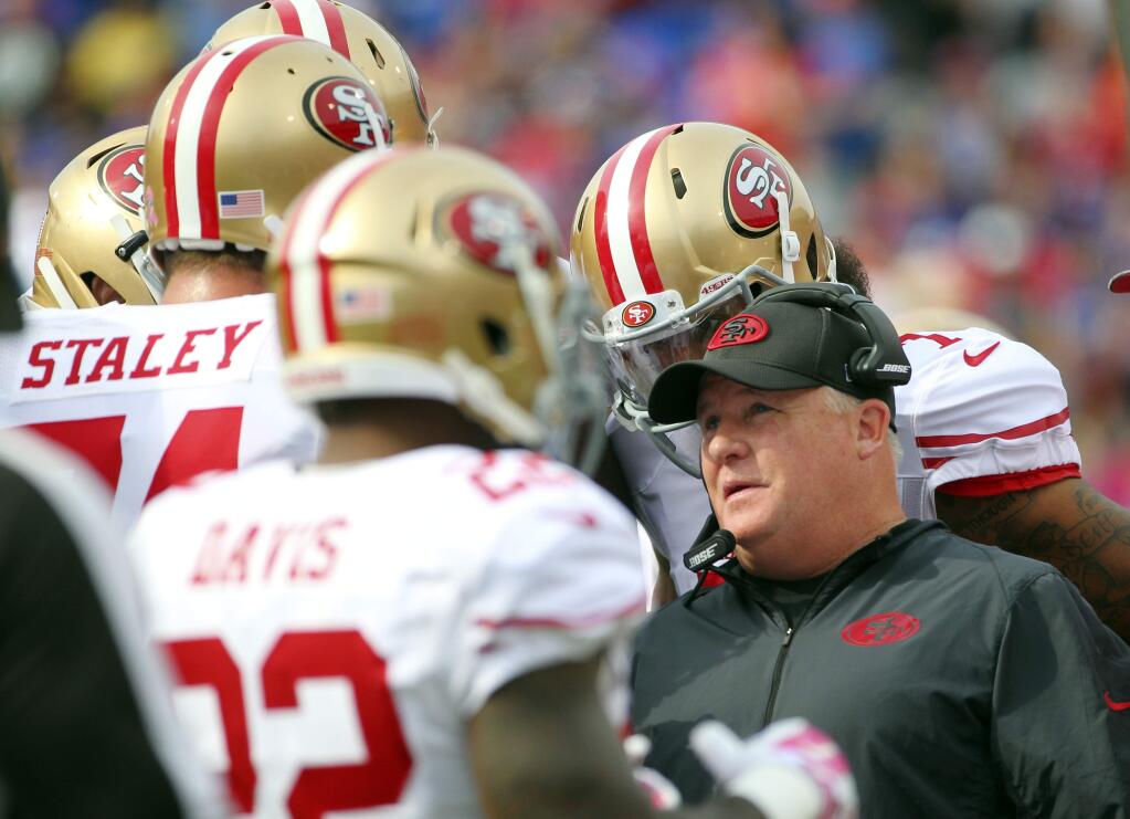 In a Sunday, Oct. 16, 2016 file photo, San Francisco 49ers head coach Chip Kelly talks to his players during the first half against the Buffalo Bills, in Orchard Park, N.Y. (AP Photo/Bill Wippert, File)