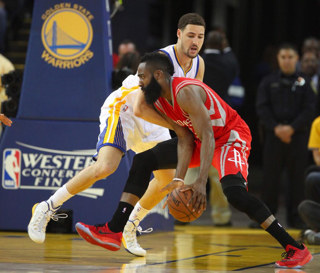 Golden State Warriors guard Klay Thompson defends against Houston Rockets guard James Harden during Game 2 of the NBA Playoffs Western Conference Finals at Oracle Arena, in Oakland on Thursday, May 21, 2015. (Christopher Chung/ The Press Democrat)