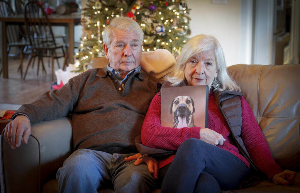Anna and Phil Henry hold a picture of their dog, Huck, who was shot and killed in the front yard of their neighbor Nick Frey’s house last September. Frey, who is the head of the Novato Police Department SWAT team and a de-escalation expert, said the shooting was in self-defense. Tuesday, Dec. 20, 2022. (CRISSY PASCUAL/ARGUS-COURIER STAFF)