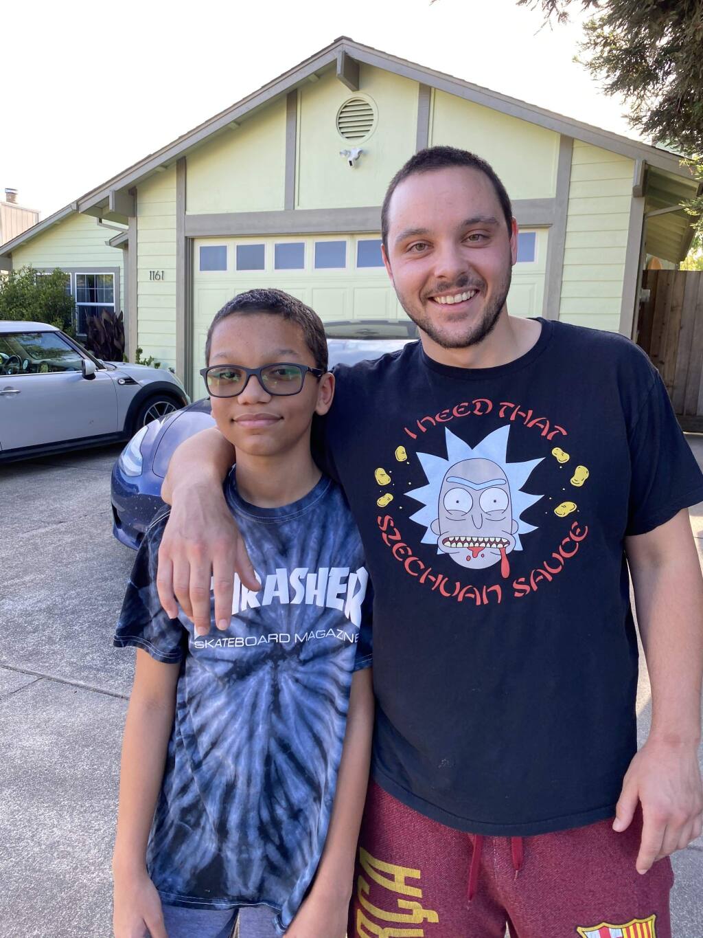 Markus Wright, left, poses for a photo with Cosmo Sutcliffe after Wright's mother, Melany Collett, not pictured, cut their hair in her garage in Santa Rosa. (Melany Collett)