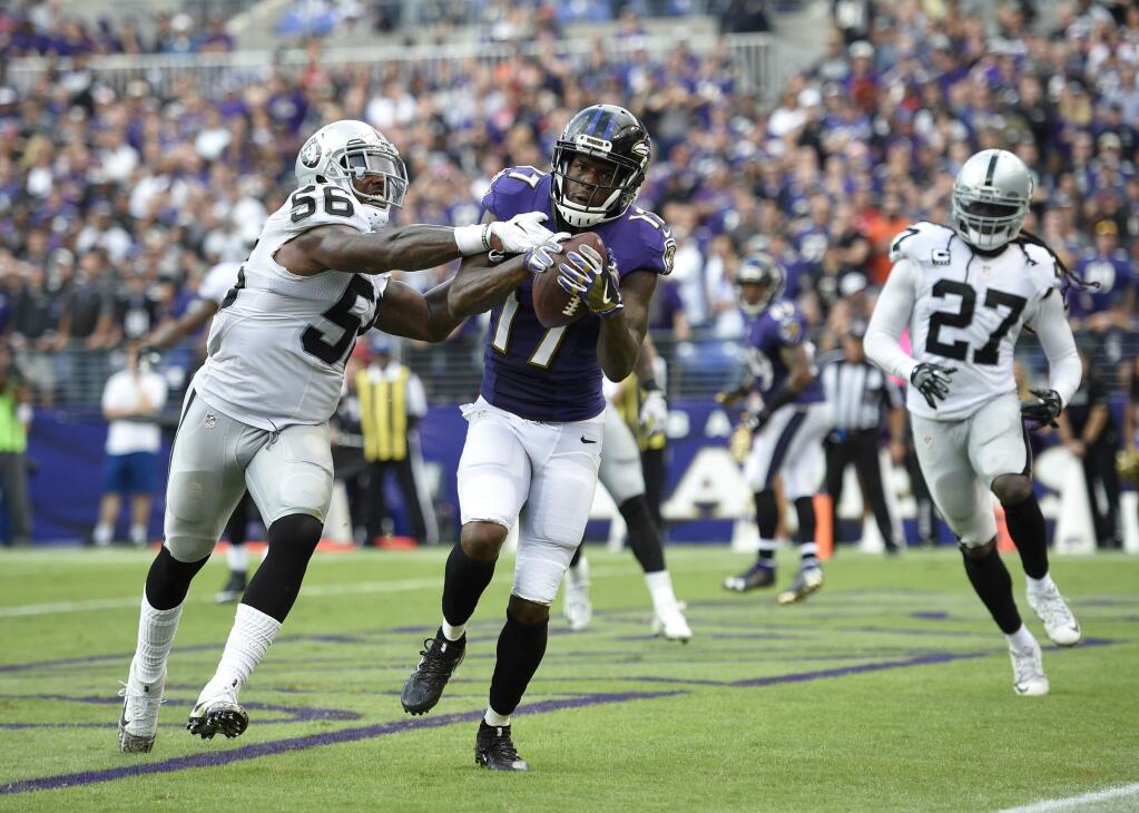 Baltimore Ravens wide receiver Mike Wallace catches the ball to score a two -point conversion in the second half against Oakland Raiders linebacker Daren Bates, Sunday, Oct. 2, 2016, in Baltimore. (AP Photo/Nick Wass)