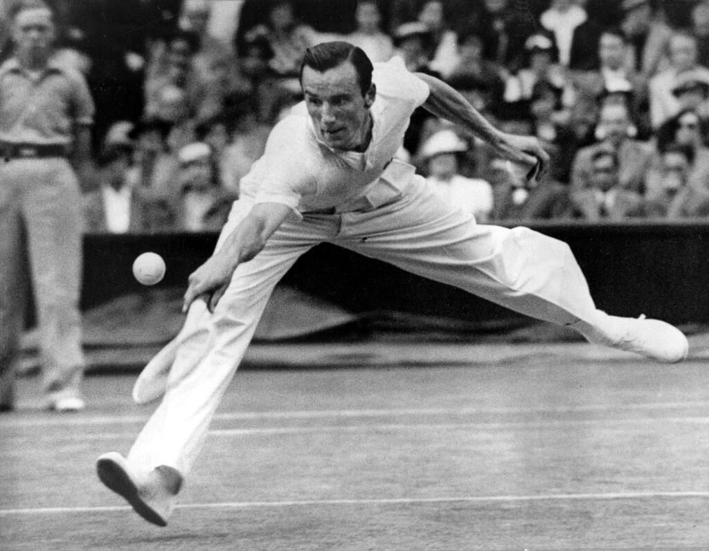 FILE - In this July 3, 1936 file photo, Fred Perry of Britain is shown in action in Wimbledon's Men's Singles at the All England Club in Wimbledon, London. When Perry won his third straight Wimbledon in 1936, its unlikely that he would have thought it would take another 77 years before another British player would triumph next. But thats exactly what happened _ Andy Murray ending the drought in 2013. Perrys name, like Lacostes before him, lives on in the fashion label that launched at Wimbledon in 1952. (AP Photo, File)
