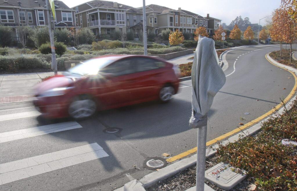 A car is a blur as it makes its way past a nonworking safety light equipped crosswalk at the roundabout at Petaluma Blvd. South and Crystal Ln. in Petaluma on Monday, November 23, 2015. (SCOTT MANCHESTER/ARGUS-COURIER STAFF)