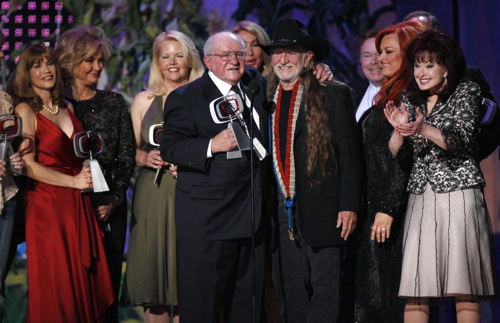 FILE - In this April 14, 2007, file photo, producer Sam Lovullo, center left and singer Willie Nelson, right along with the cast of the television show 'Hee Haw' accept the Entertainer's Award during the 5th Annual TV Land Awards in Santa Monica, Calif. Publicists the Brokaw Company said Thursday, Jan. 5, 2017, that Lovullo died at his home in Los Angeles on Tuesday. He had been suffering from heart disease. He was 88. (AP Photo/Gus Ruelas, File)