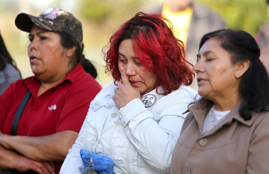 Sujay Lopez, center, prays with friends during a memorial for her 13-year-old son Andy Lopez, who was killed three years ago by a Sonoma County Sheriff's deputy at the future site of Andy's Unity Park in Santa Rosa. (John Burgess/The Press Democrat)