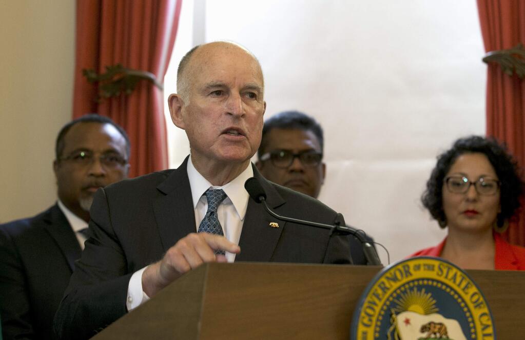 FILE - In this June 13, 2017, file photo, California Gov. Jerry Brown discusses climate change at a news conference in Sacramento, Calif. Gov. Brown plans to convene a Global Climate Action Summit next year in his latest action to position the state as a leader in battling global warming as the White House recedes. (AP Photo/Rich Pedroncelli, File)
