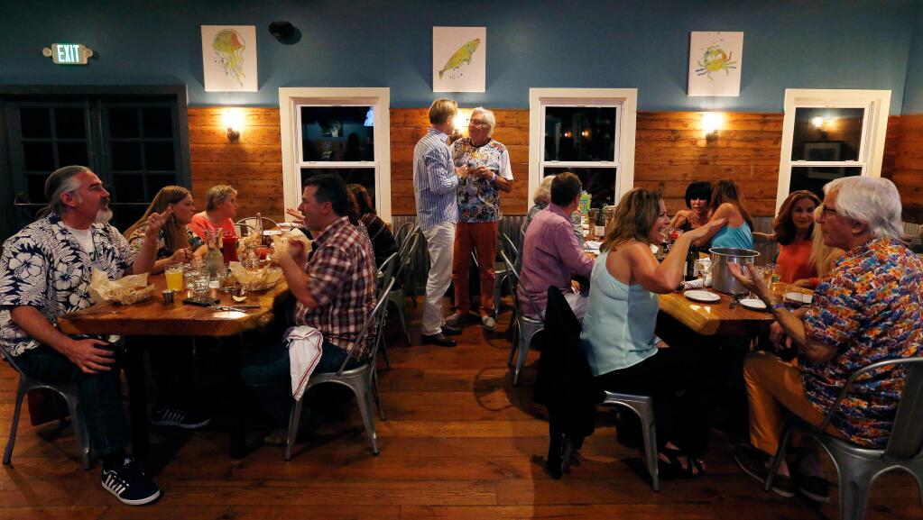 Guests enjoy dinner and conversation at the Reel Fish Shop and Grill, in Sonoma, California, on Saturday, April 1, 2017. (Alvin Jornada / The Press Democrat)
