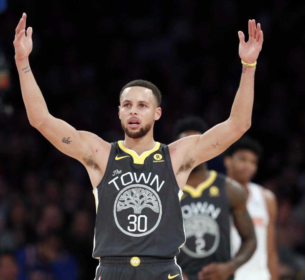 Golden State Warriors forward Stephen Curry celebrates toward fans during the second half of an NBA basketball game against the New York Knicks, Monday, Feb. 26, 2018 in New York. The Warriors defeated the Knicks 125-111. (AP Photo/Kathy Willens)