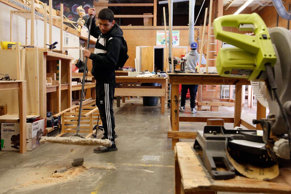 Piner High senior Miguel Gonzalez cleans up after the Project Make class before the final school bell rings, at Piner High School in Santa Rosa, California, on Thursday, February 22, 2018. (Alvin Jornada / The Press Democrat)