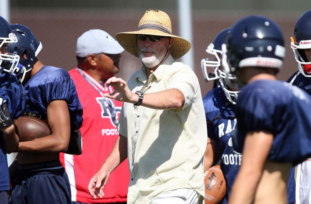 Head coach Ed Conroy talks to his players during Rancho Cotate football practice in Rohnert Park, Friday, August 22, 2014.(Crista Jeremiason / The Press Democrat)