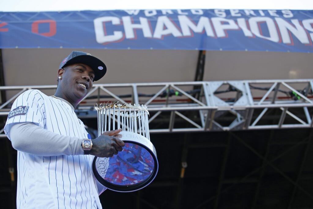 Chicago Cubs' Aroldis Chapman holds the Commissioners Trophy during a celebration honoring the World Series champions at Grant Park in Chicago, Friday, Nov. 4, 2016. (AP Photo/Nam Y. Huh)