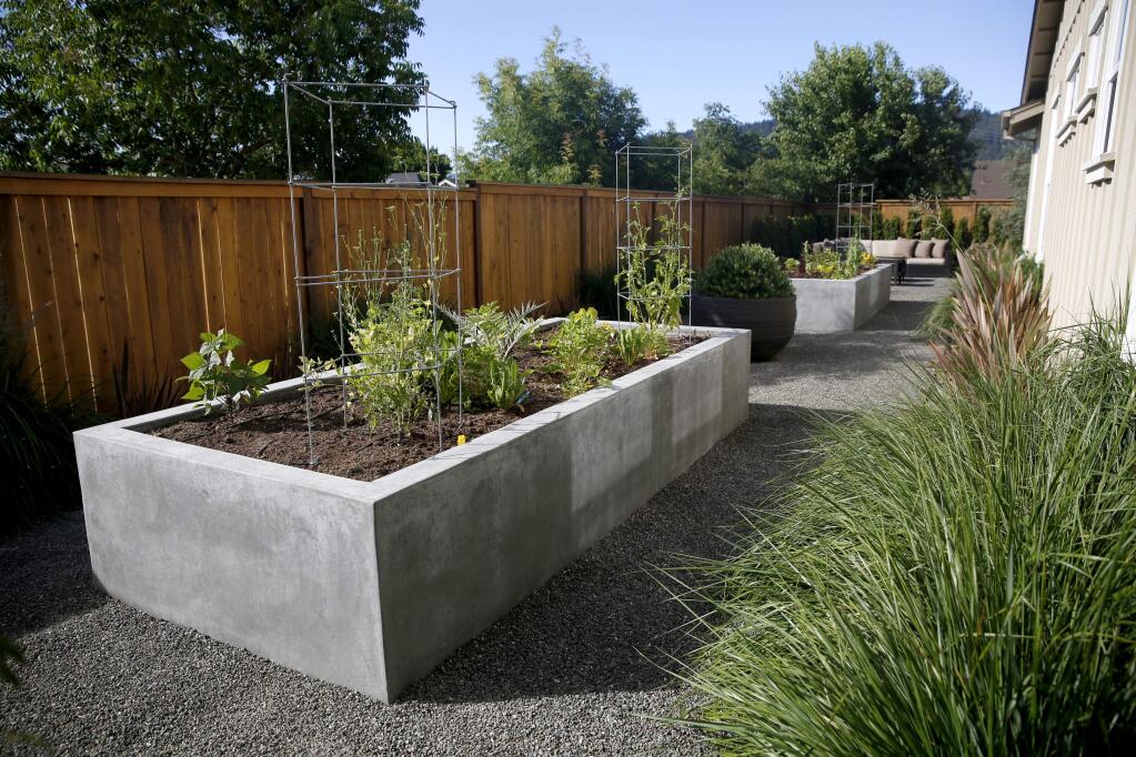 Concrete vegetable planters and loose stone pathways create a clean look in a new contemporary garden designed by Kris Sunderlage in the Oakmont community in Santa Rosa, on Monday, June 29, 2015. (BETH SCHLANKER/ The Press Democrat)