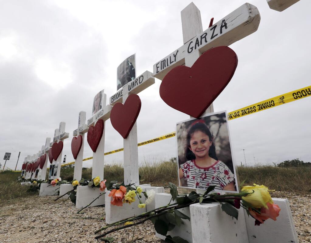Crosses showing shooting victims names stand near the First Baptist Church on Thursday, Nov. 9, 2017, in Sutherland Springs, Texas. A man opened fire inside the church in the small South Texas community on Sunday, killing more than two dozen and injuring others. (AP Photo/David J. Phillip)