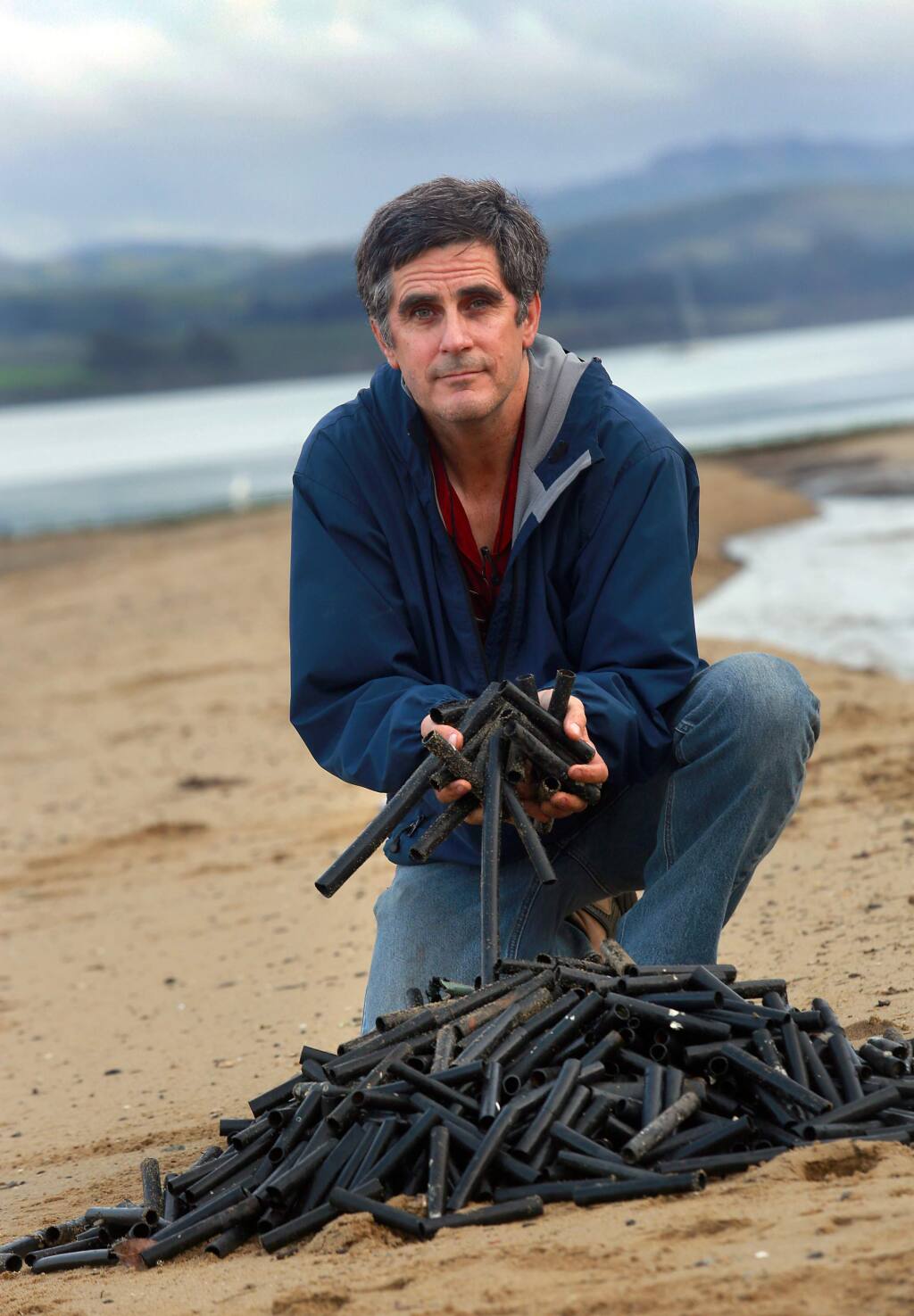 Richard James has collected thousands of black plastic tubes from the beaches of Point Reyes National Seashore over the past six years. While he links the tubes and other debris to the Drakes Bay Oyster Co., company co-owner Kevin Lunny points to previous oyster operations at the site. (Photo by John Burgess/The Press Democrat)