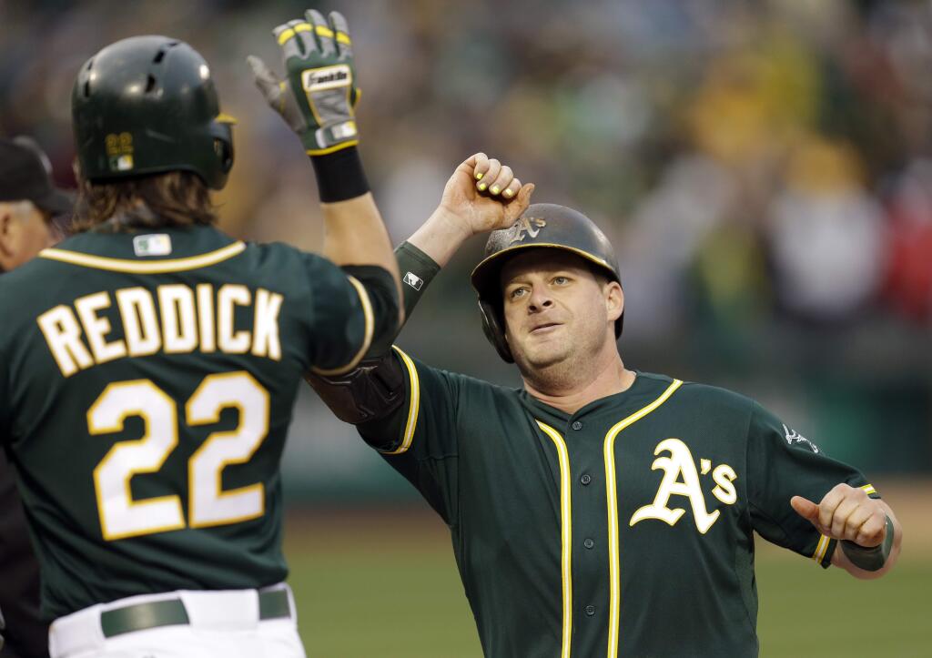 Oakland Athletics' Stephen Vogt, right, celebrates with Josh Reddick (22) after Vogt hit a two-run home run off Boston Red Sox pitcher Justin Masterson during the first inning of a game Tuesday, May 12, 2015, in Oakland. (AP Photo/Ben Margot)