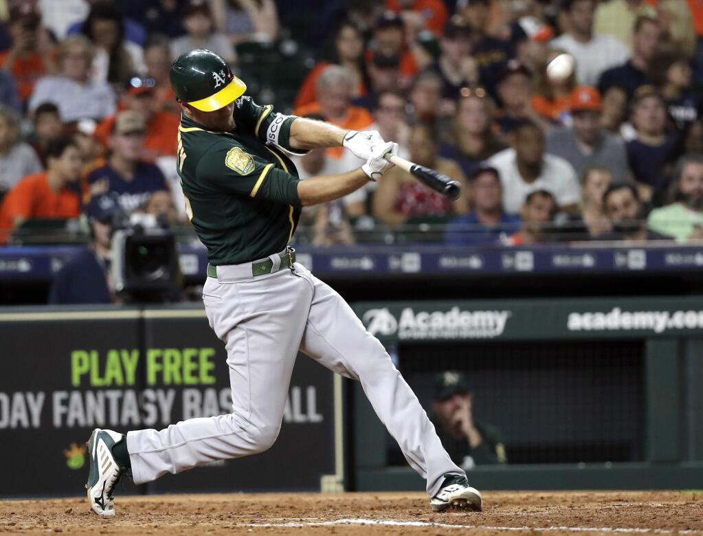 Oakland Athletics' Stephen Piscotty hits a home run against the Houston Astros during the seventh inning of a baseball game Monday, July 9, 2018, in Houston. (AP Photo/David J. Phillip)