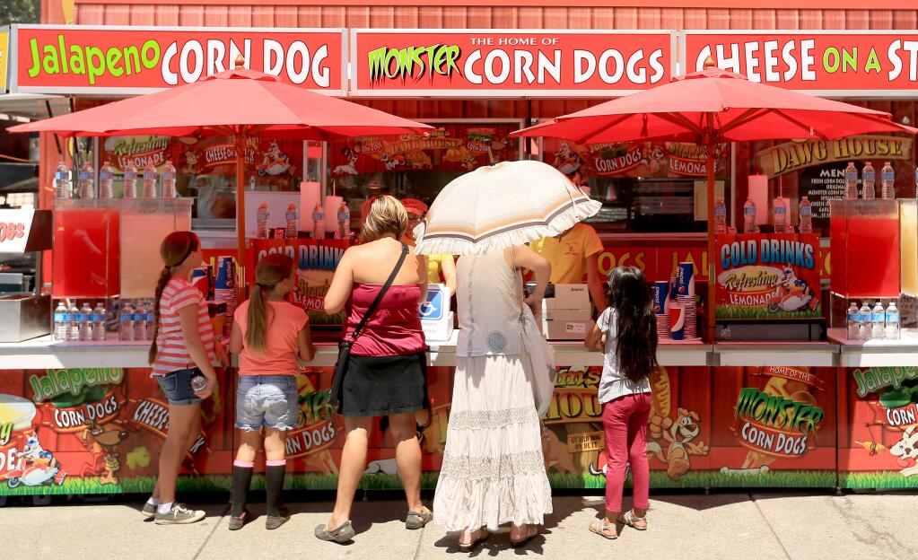 Fairgoers have a plethora of food choices at the Sonoma County Fair, Wednesday July 30, 2014 in Santa Rosa. (Kent Porter / Press Democrat) 2014