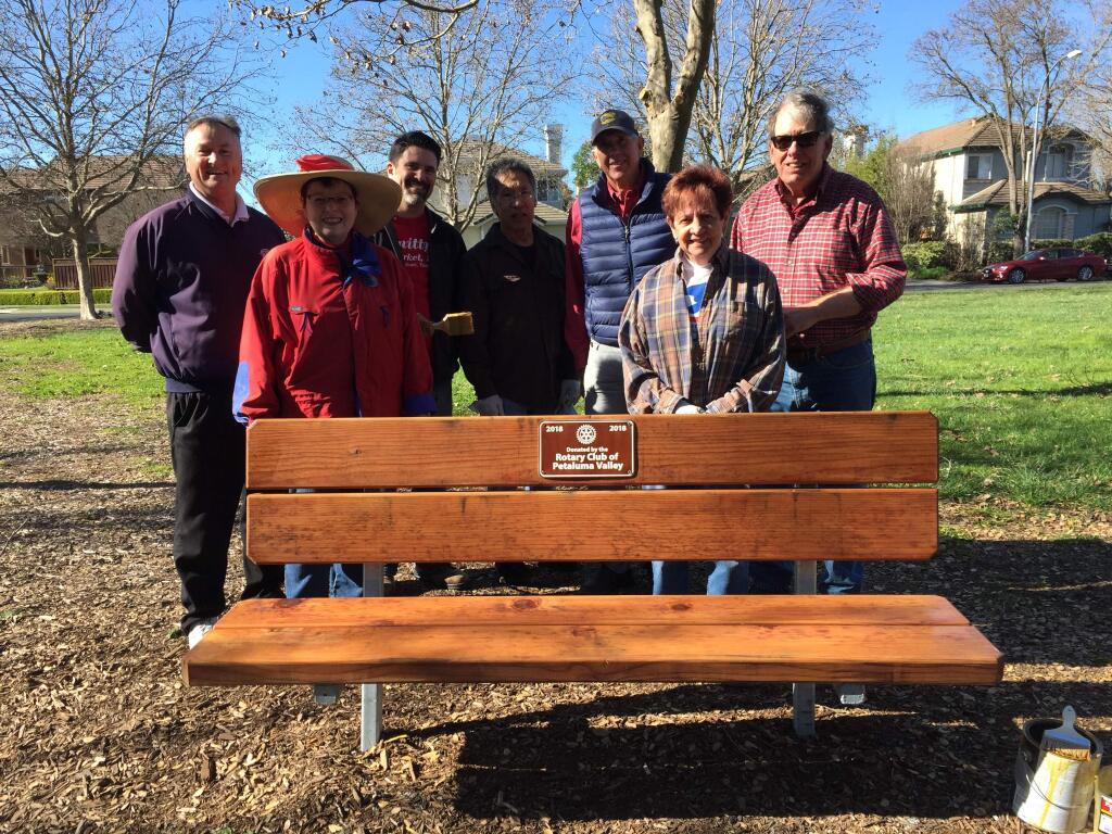 Members of the Petaluma Valley Rotary Club with one of two new benches they purchaed and installed on the Capri Creek Walking Trail.