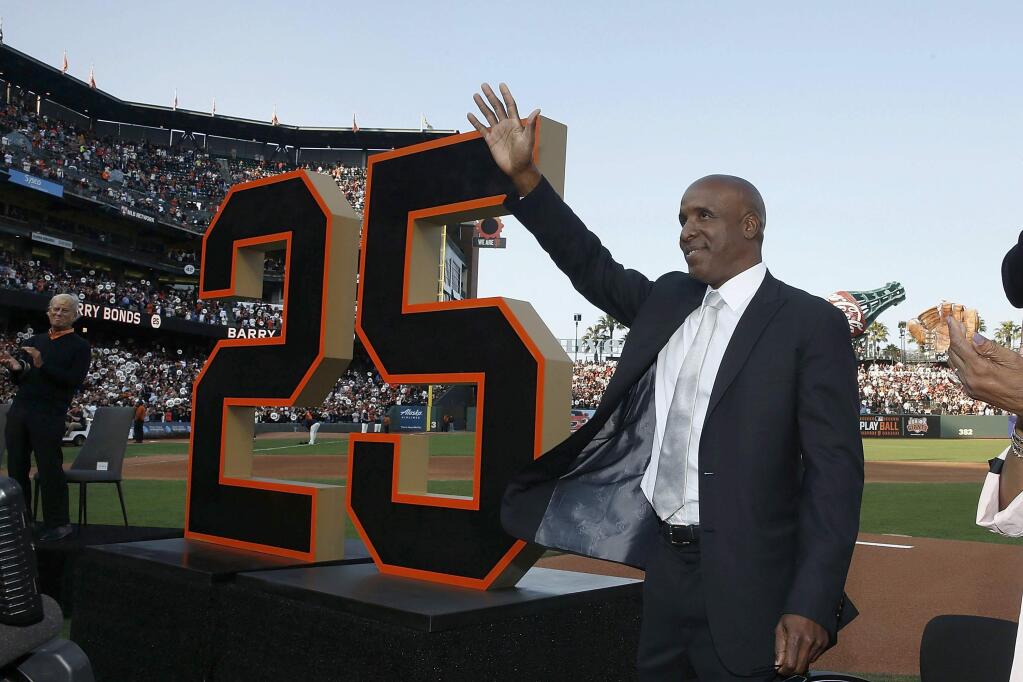 Former San Francisco Giants player Barry Bonds waves during a ceremony to retire his jersey number before a game between the Giants and the Pittsburgh Pirates in San Francisco, Saturday, Aug. 11, 2018. (Lachlan Cunningham/Pool Photo via AP)