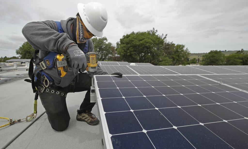 The California Public Utilities Commission will vote soon on a proposal to impose a monthly fee on owners of rooftop solar systems who feed excess power back onto the grid. (BEN MARGOT / Associated Press)